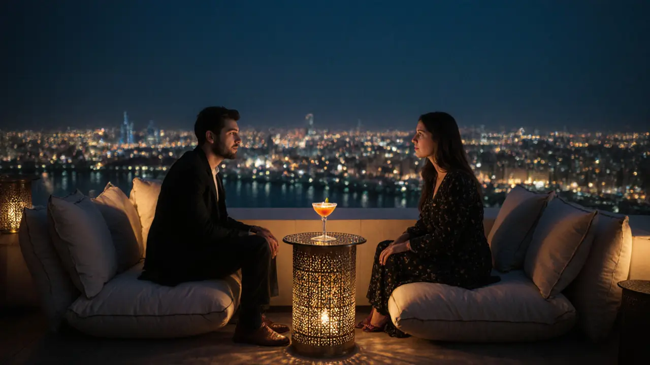 Couples enjoying quiet conversation on a rooftop at dusk with city lights and cocktails in the background.