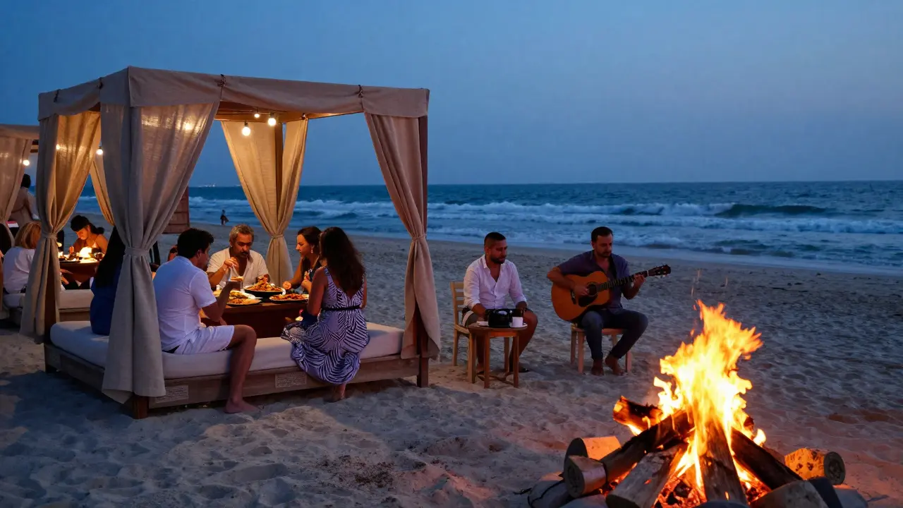 Beachside lounge with bonfires, string lights, and guests dining by the ocean at night.